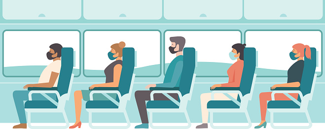 Passengers wearing protective medical masks travelling by bus or train. Travel during coronavirus COVID-19 disease outbreak.