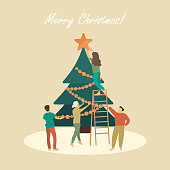 People decorate the Christmas tree, happy people celebrate Christmas.