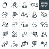 An icon set of people taking photos using a camera or mobile phone that include editable strokes or outlines using the EPS vector file. The icons include a hand holding a mobile phone with a camera lens attached, person taking photos using a DSLR camera, person taking photos using a mobile phone, person taking a selfie with mountain landscape in the background, person taking selfie, person taking picture of another person, person taking pictures from a DSLR camera on a tripod, two people taking a selfie, hand holding a mobile phone and taking a picture of a flower, person editing photos on laptop computer, mobile phone taking a picture from a selfie stick and other related icons.