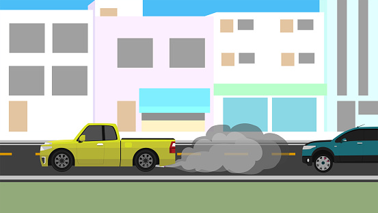 Pickup trucks racing on city streets. It releases smoke and pollution to the cars that follow behind them. With city for backgorund at day.