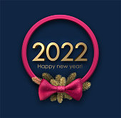 Pink round Christmas wreath with 2022 sign. Fir branches and bow. Vector holiday illustration.