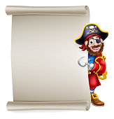 A pirate captain cartoon character peeking around a scroll sign background and pointing at it with his hook