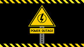Power outage sign on a black background with yellow black stripes. Yellow black banner. Yellow warning sign. Yellow power outage placard. Electricity, power outage, short circuit, high voltage, danger concepts.