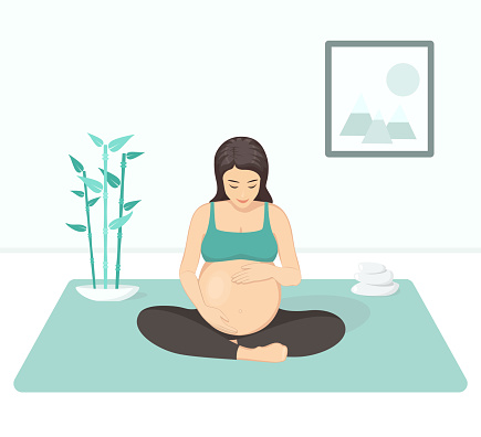 Pregnant woman practices yoga and meditation