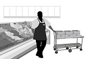A produce manager is standing next to a cart full of boxes.  He is in the produce section of a grocery store.  This vector silhouette  illustration is black and white with grey tones for added details.