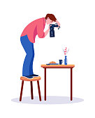 Professional photographers. Woman standing on chair taking pictures of served table. Female photos meal for portfolio, magazine. Photography for restaurant menu, hobby or food blog vector concept