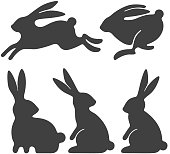 Rabbit set. Stylized silhouettes of sitting and running rabbits, isolated on white background. Vector illustration.