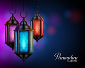 Ramadan Kareem Greetings with Colorful Set of Lanterns or Fanous in a Dark Glowing Background. 3D Realistic Vector Illustration