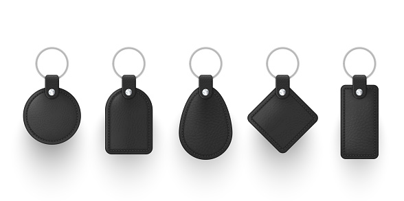 Realistic black leather keychains with metal ring vector illustration. Set of holder trinket to key