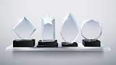 Realistic glass trophy awards, transparent diamond winner prizes on shelf vector illustration. Collection of award and trophy transparent glass