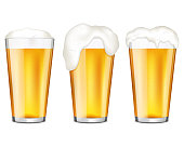 istock Realistic glasses of beer with bubbles and flowing white foam, isolated on white background. 1309061962