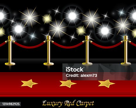 istock Red Carpet with Poles and Barrier Rope in front of Paparazzi Flashes 1314982925