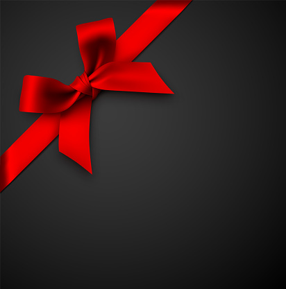 Red Gift Bow with Ribbon on a Black Background