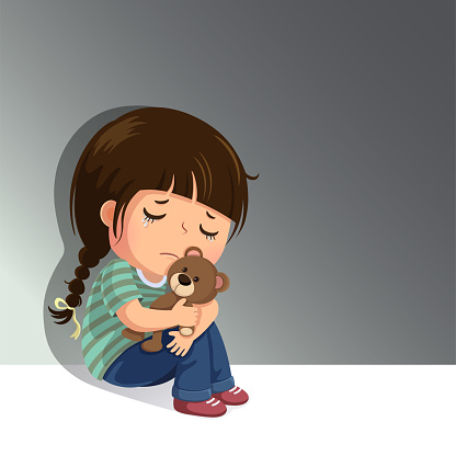 Sad little girl sitting alone with her teddy bear