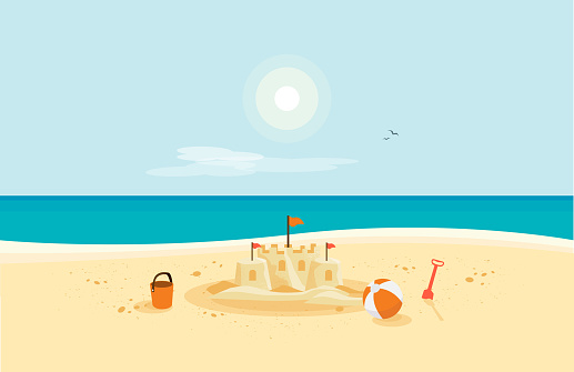 Sand Castle on Sandy Beach with Blue Sea Ocean and Clear Summer Sunny Sky