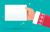 Santa Claus holiday Christmas hand holding gift card sign or information with space for your copy.