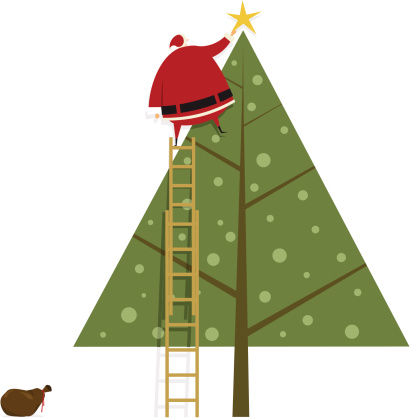 Santa Claus putting the star on christmas tree