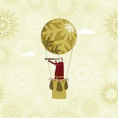 Christmas card with Santa flying by hot air balloon to share out sweets and gifts amongst the children of the world.