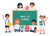 istock School children in class with a blackboard, back to school concept, cute characters. Vector illustration in flat style 1333654744