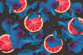 istock Seamless pattern with blue orchids and grapefruit rings 1318490769