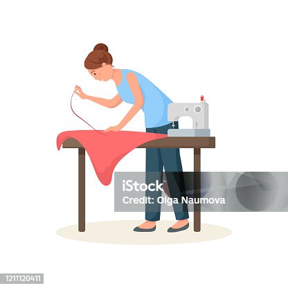 istock Seamstress leaned over table and hemming red cloth 1211120411