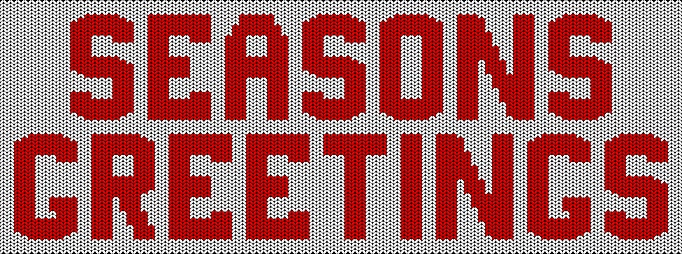 seasons greetings inscription knitted on a white background red yarn