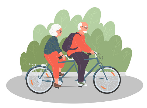 Seniors couple together riding tandem bike outdoors