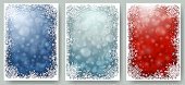 Set of Christmas cards with white frame of snowflakes. Winter illustrations with blue and red blurred bokeh backgrounds and copy-space. Vector.
