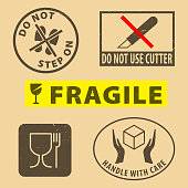 istock Set of fragile sticker handle with care and case icon packaging symbols sign, do not use cutter, do not steo on rubber stamp on cardboard background, vector illustration. Use on package. 1354183410