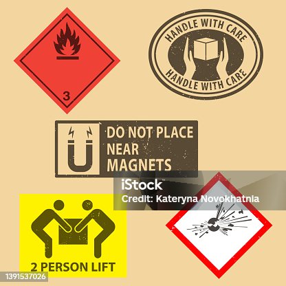 istock Set of fragile sticker handle with care and case icon packaging symbols sign, Do Not Place Near Magnets, Flammable liquids, Explosives  rubber stamp on cardboard background. Use on package. 1391537026