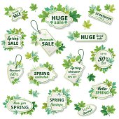 Bright green sale tags with assorted maple leaf  decorations. The tags have a drop shadow and a thin border inside. There is text inside. There are various shaped labels decorated with leaves.