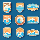 Set of nine summer holidays emblems. Labels with sun, waves, and sand in bright blue and orange colors. Beach emblems, badges and logo patches. Summer holidays, surfing. Vacation labels in vintage style