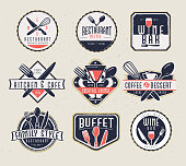 Vector illustration of a set of Restaurant menu and bar labels with unique shapes and text designs as well as utensils and drinkware. Includes Restaurant Menu, Wine Bar, Kitchen & Cafe, Cocktail Lounge, Coffee & Dessert, Family Style Restaurant and buffet text designs as well as fork,spoon,knife,whisk,coffee cup, wine glass and cocktail glass. Unique and retro set of badges. Fully editable EPS 10.