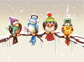 Four birds with wooly hats and scarfs sitting on a branch. It's cold and snowing and one of them even has small icicles on its frozen blue foot. Concept for coldness, tourism, heatings, bad weather... 