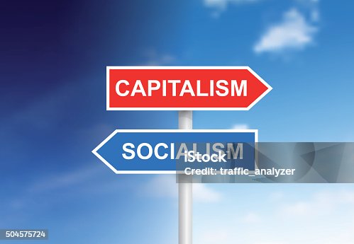 istock Signs "Capitalism" and "Socialism" over sky 504575724