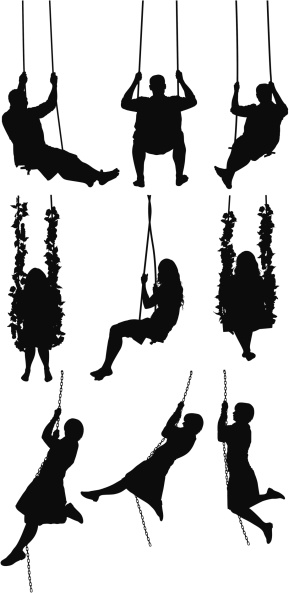 Silhouette of people swinging on swings