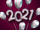 Silver 2021 sign balloons and oval balloons with threads. Dark red background. Space for text. Vector holiday illustration.