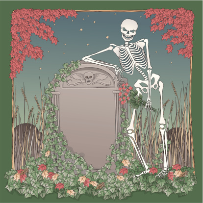 Skeleton on Halloween night leaning gravestone.