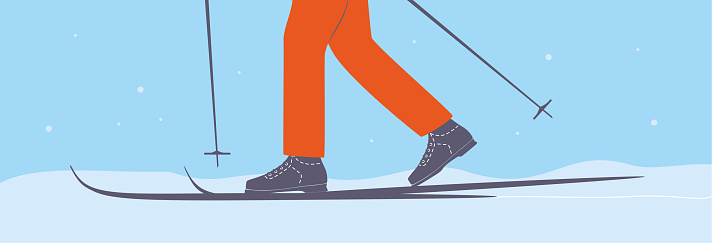 Skier with ski poles on snow ski track. Skis. Person cross-country skiing.
