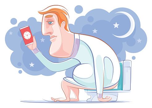 sleepless man sitting on toilet bowl and looking at smartphone
