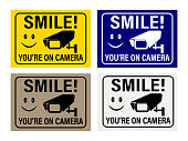 istock Smile you're on camera. Video Surveillance Signs. You are on camera signs and stickers. 1347615724