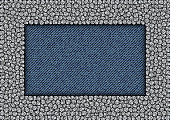 Silver sequin rectangle frame on blue jeans background.