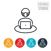 An icon of a student working on laptop while wearing a face mask. The icon includes editable strokes or outlines using the EPS vector file.