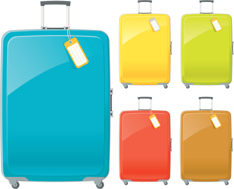 Suitcases in blue, yellow, green, red and brown with tags