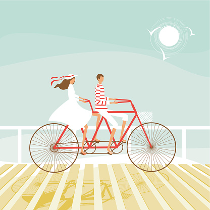Summer couple cycling on the beach