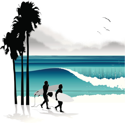Surfers walking in a tropical beach