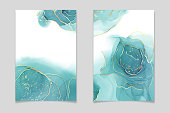 istock Teal blue and mint colored liquid watercolor background with gold stains and dots. Luxury minimal turquoise hand drawn fluid alcohol ink drawing effect. Vector illustration design template 1322566567