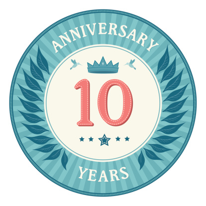 A vintage style ten years anniversary badge with a laurel wreath, crown and hummingbird motifs. This is a fully editable EPS 10 vector illustration with CMYK color space.