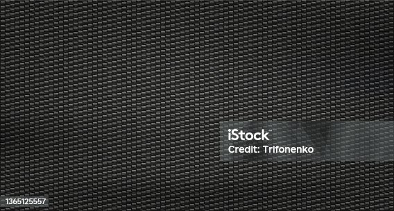 istock Texture black carbon fiber. Kevlar surface pattern. 1365125557