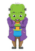 istock The boy with the big head zombie costume is holding the basket 1338959628